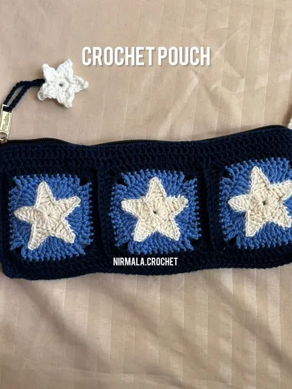 A full view of the Starry Night pouch, featuring three star-patterned granny squares and a matching star charm.