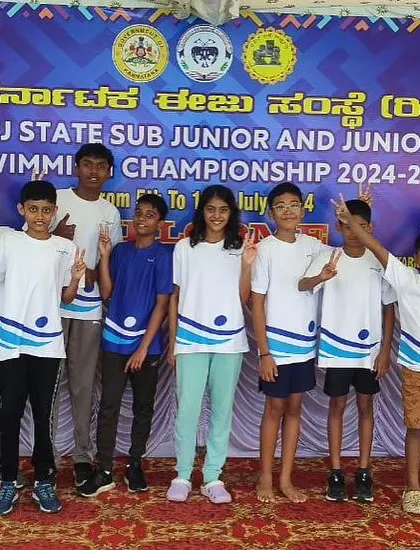 The team spirit is high as our young swimmers celebrate their achievements at the state championship.