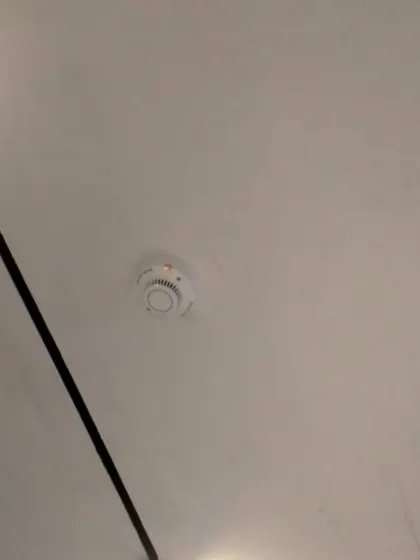 A cleanly installed smoke detector on a finished ceiling. We make sure our installations are neat and discreet, providing reliable smoke detection for homes, offices, and commercial spaces.