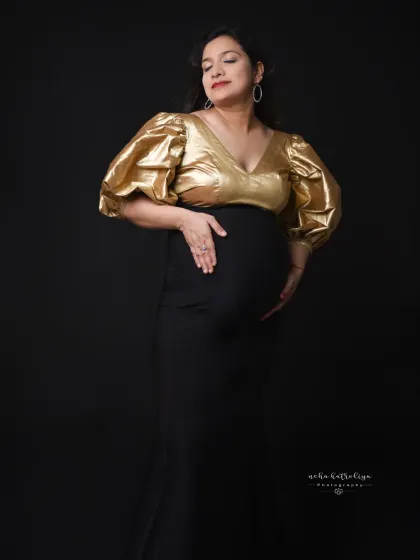 A gentle and loving pose, cradling the bump. This shows the softer side of a bold and modern maternity look.