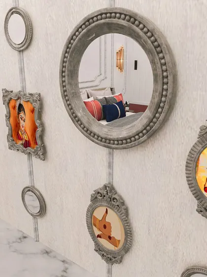 A gallery wall of antique-finish mirrors and framed art, creating a unique and personal feature in this European-inspired bedroom.