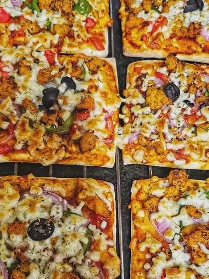 For the non-veg lovers, I offer these delicious Tandoori Chicken pizzas. The spicy chicken and melted cheese on a flatbread base are a guaranteed crowd-pleaser.