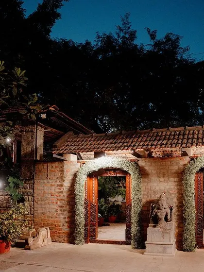The entrance to the Sangeet venue, with arches decorated with fresh greenery.