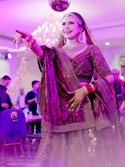 The bride's solo dance performance, capturing her energy and the vibrant lighting of the event.
