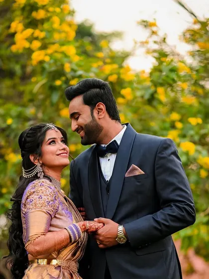 A romantic portrait of the couple surrounded by yellow blossoms. We use the natural environment to create a beautiful and colorful frame for your photos.
