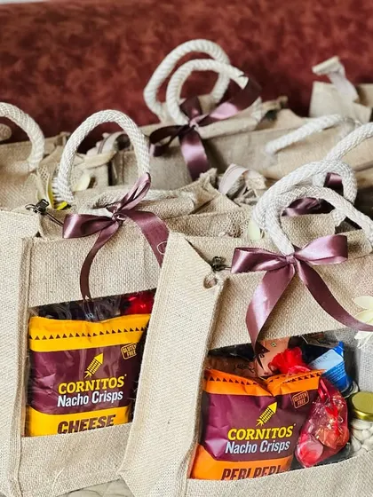 A batch of jute bags with a clear window to see the snacks inside. These are great for casual corporate gifting for employees.