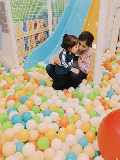 A mother and child share a sweet moment in the ball pit at our Ashok Vihar center, a perfect space for sensory exploration and fun.