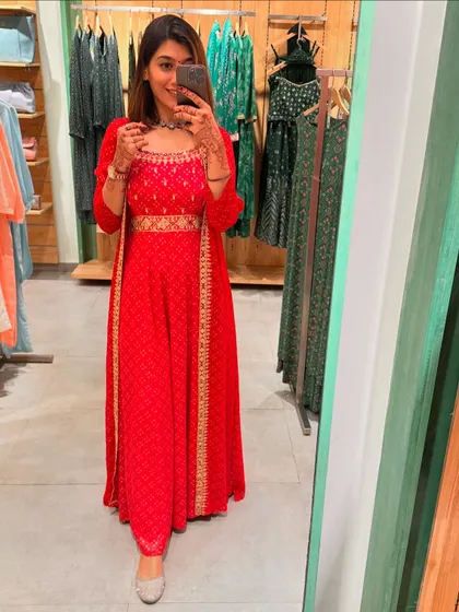 A closer look at the red Anarkali set. The rich color and gold detailing make it a truly festive and royal choice.