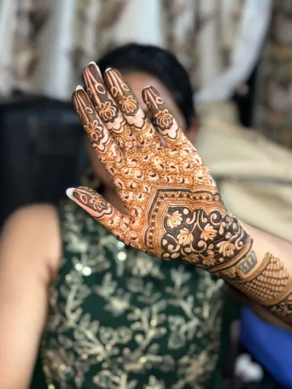 The back of the hand, featuring a lovely floral and paisley pattern.