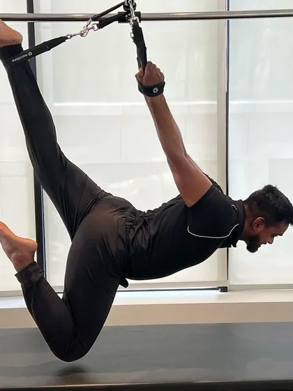 A demonstration of grace and power. This pose on the Cadillac lengthens the spine while engaging the entire posterior chain.