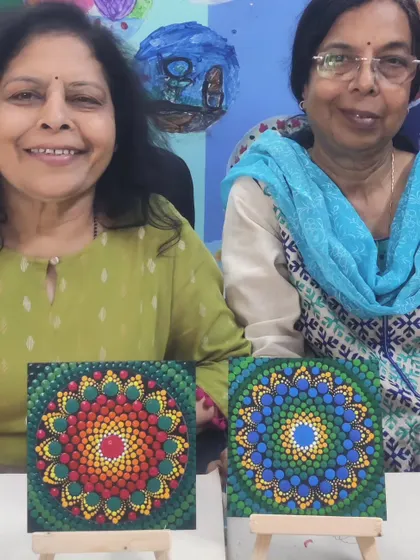 Two friends enjoying a dot painting session together at the ArtBox Studio. They each created a unique and colourful mandala on a small canvas, showcasing their individual styles while sharing a creative experience.