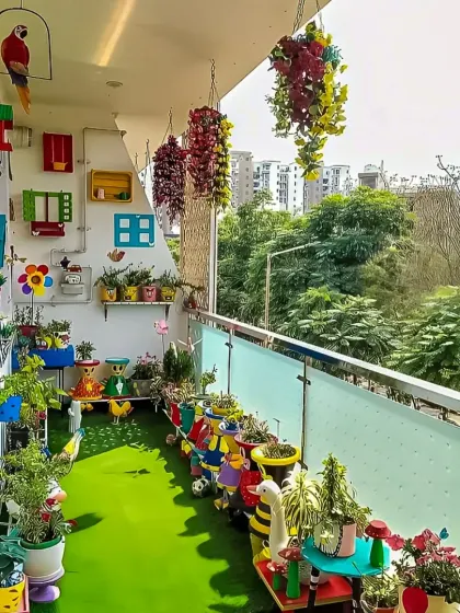 A playful and colorful balcony garden designed for a family. The space is filled with whimsical, brightly painted planters and birdhouses, creating a fun outdoor activity area.
