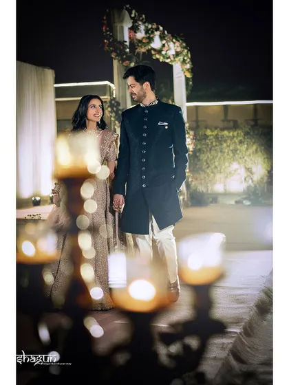 A beautiful couple portrait with soft, romantic lighting from the candles in the foreground.