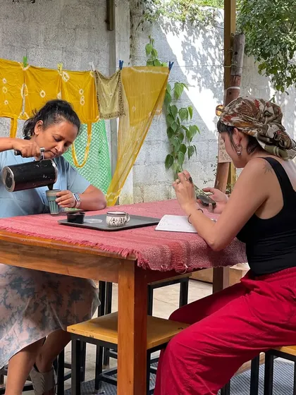 Pouring a cup of coffee during a meeting with visiting artists. The background shows tie-dyed fabrics, a testament to the creative energy that flows through our space.