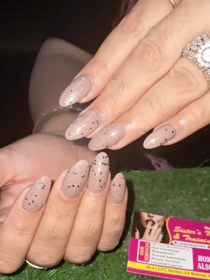 A unique and stylish design with a speckled nude polish that looks like a quail egg, perfect for a subtle but interesting look.