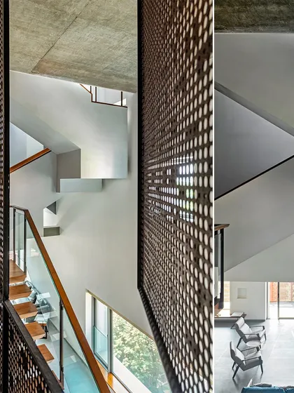 The multi-story interior of J-House is connected by a network of voids and staircases, with perforated screens allowing light and air to flow vertically through the home.