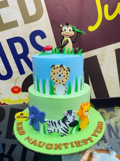 A 3kg two-tiered jungle cake with a mix of 2D and 3D animal decorations.