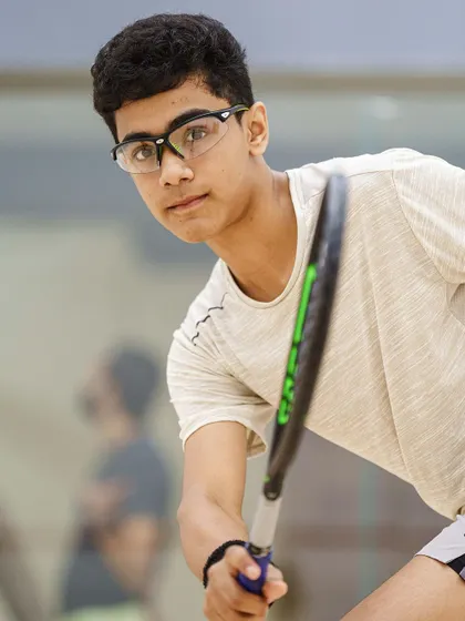 A close-up portrait of 15-year-old Abdus Samad, another rising star on the Goan squash team. The sharp focus and determined look highlight the intensity he brings to the court.