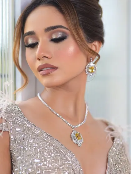 A serene, eyes-closed shot that allows a full appreciation of the blended eyeshadow and the radiant highlighter on the cheekbones.