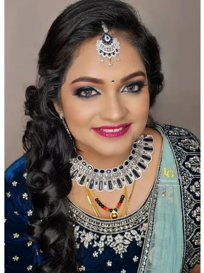 Another stunning portrait of Akshatha, highlighting the flawless application of her reception makeup.