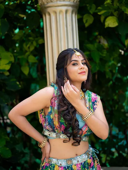 Another confident pose from the same series. Her expression and gesture add a touch of traditional elegance to the modern, colorful outfit.