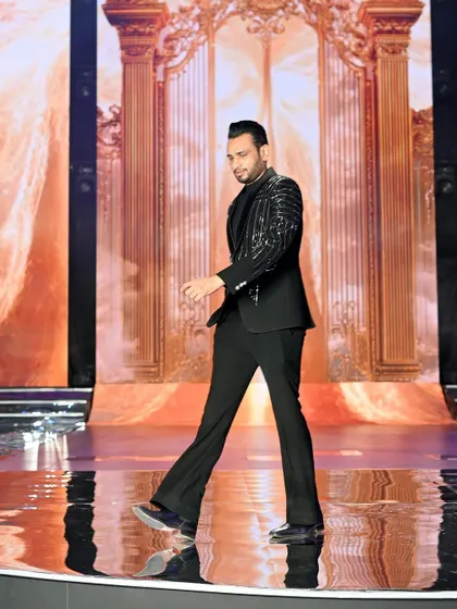 The show director on the runway. Capturing the key people behind the scenes is just as important as capturing the contestants.