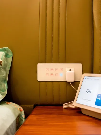 A complete bedside control setup with a smart panel for touch control and a Google Nest Hub for voice commands and visual feedback.