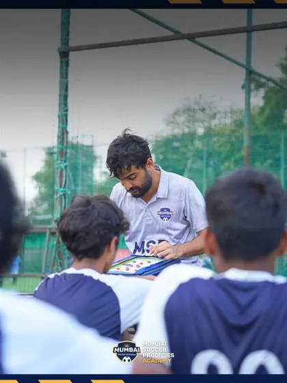 A coach strategizes with the team, a moment of focus during a successful tournament run.