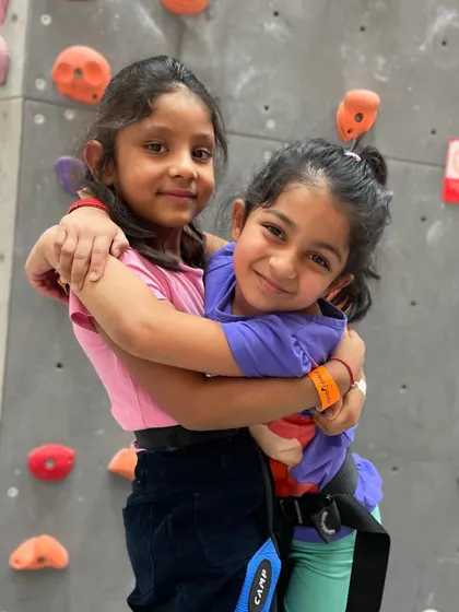 Best friends at the climbing gym! It's a wonderful place for kids to socialize, support each other, and share a healthy, active hobby.