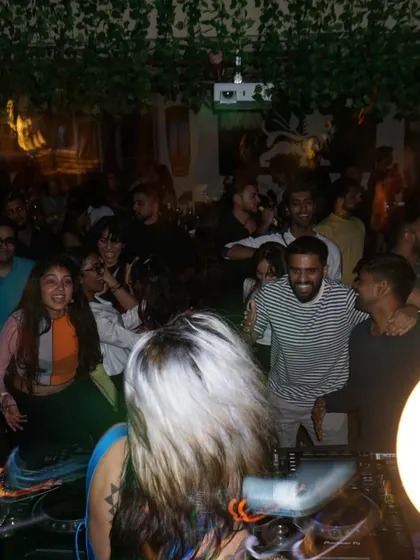 A view from behind my shoulder, looking out at a happy, dancing crowd.