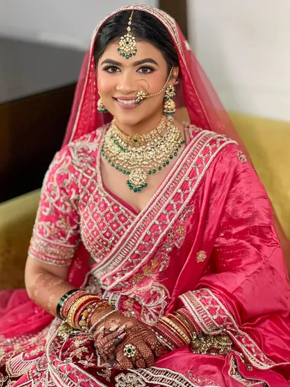 A portrait of the happy bride, showcasing her flawless makeup and traditional hairstyle.