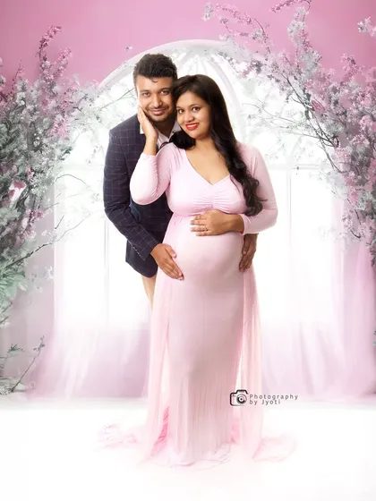 A lovely couple's portrait in a dreamy pink floral setting. This setup is perfect for a romantic and soft-themed maternity shoot in my Gurgaon studio.