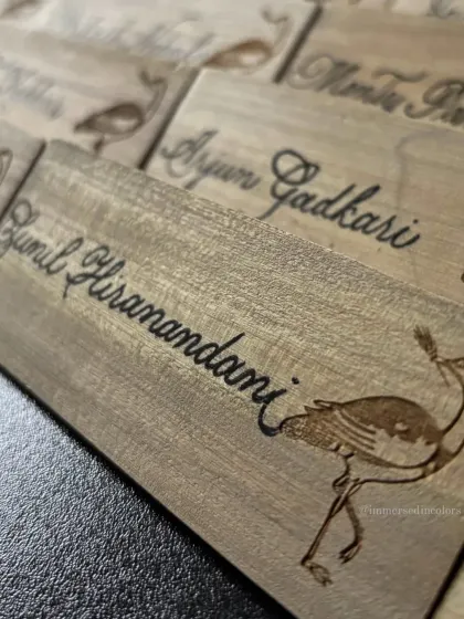 Another angle of the wooden place cards, featuring the laser-etched Godawan bird logo alongside my handwritten calligraphy. This shows how I can integrate my work with your existing event branding.