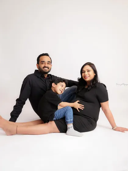 A classic family portrait with the older sibling giving the baby bump a hug. A simple, sweet, and timeless way to capture this special time.