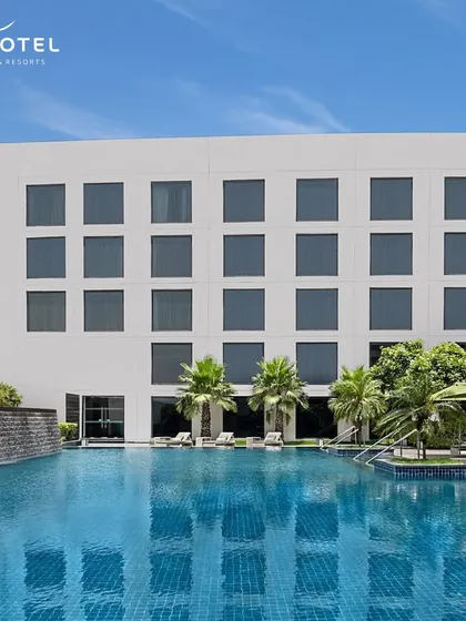 The stunning poolside of the Novotel hotel. This image highlights the beautiful and relaxing environments where you can enjoy a drink and unwind.
