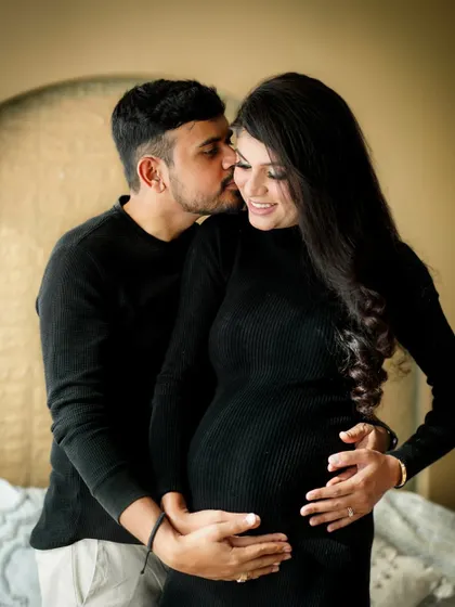A sweet and candid moment between the couple, showing the love that is the foundation of their growing family.