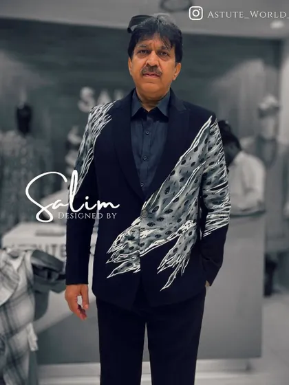 A client, singer Abhijeet Bhattacharya, wearing a custom blazer with a hand-painted abstract animal print. The design flows across the jacket for a modern and artistic effect.