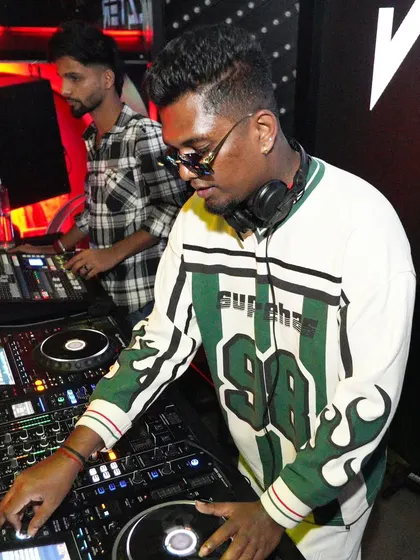 A close-up of me scratching a record on the turntable. I incorporate live mixing techniques to add a unique and energetic flair to my DJ sets.