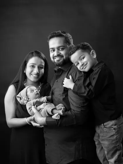 A classic black and white family portrait. This timeless style focuses on the expressions and connections between each family member, creating a powerful and elegant image.