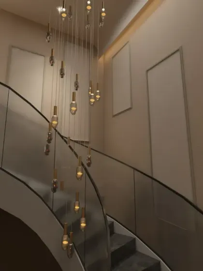 A staircase should do more than connect floors; it should elevate the home's experience. For this Gurgaon residence, I designed a curved staircase with a statement double-height chandelier and textured walls to create a sense of grandeur and a beautiful journey between levels.