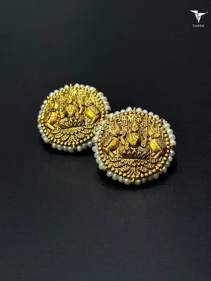 One of my most classic pieces, these 22kt gold earrings feature Maa Laxmi and are bordered with tiny pearls. This is the kind of piece that can be passed down through generations, carrying blessings with it.