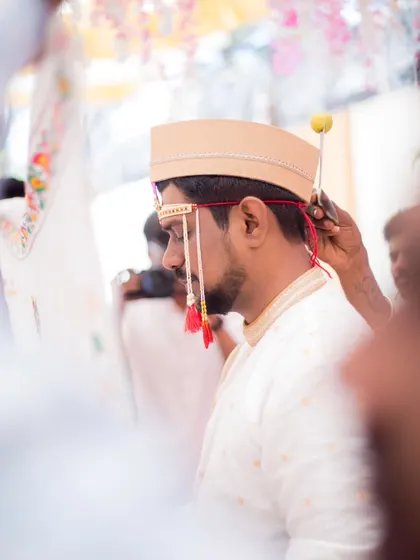A close-up shot of the groom during the wedding ceremony, capturing a moment of quiet anticipation.