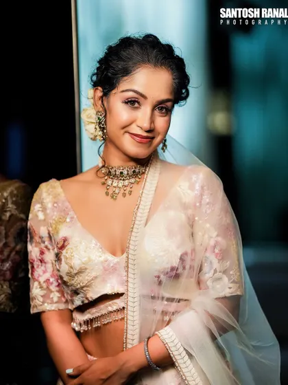 A happy and confident portrait. The model's smile brings a warm and inviting energy to the photograph.