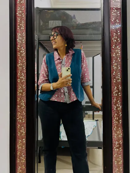 A smiling mirror selfie showing off my layered block-print look.