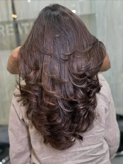 The back view shows the full effect of the layered haircut and multi-tonal brown color. Each layer is defined, creating beautiful texture and the illusion of thicker, fuller hair.