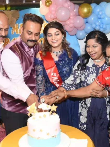 The whole family joins in for the cake-cutting, a moment of unity and celebration.