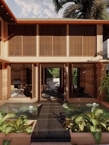 The entrance to our rammed earth villa in Morjim is designed as a journey. You walk across a tranquil lotus pond to enter the home, immediately setting a tone of serenity. This use of water and nature is central to our approach to creating calming, restorative living environments.