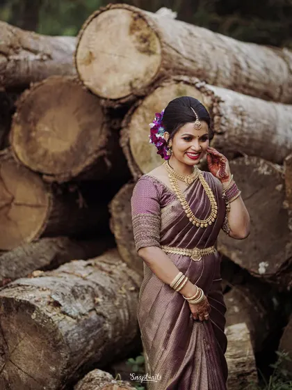 The bride smiles, her traditional attire and joyful demeanor captured perfectly in this outdoor portrait session.