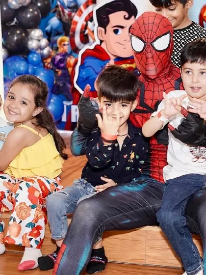 Kids having a blast with Spider-Man at a superhero-themed party. Our mascot visits are a highlight of our exclusive packages.