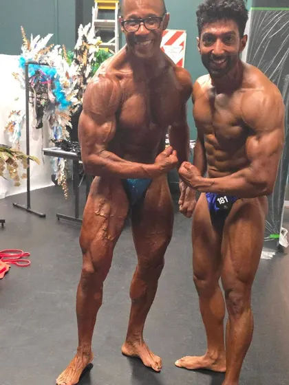 Posing with a fellow master's competitor. Natural bodybuilding is a sport for all ages.